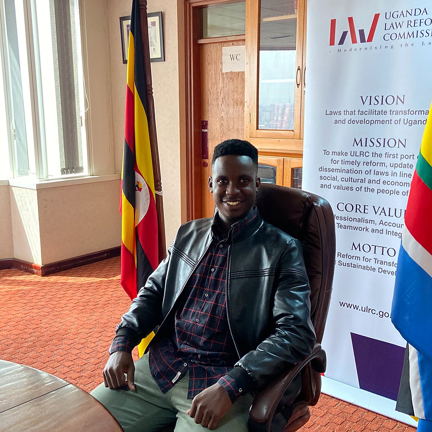 Joshua Kakembo seated in a boardroom